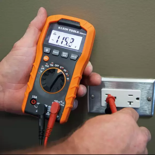 Electrician testing an outlet with a Klein Digital Multimeter