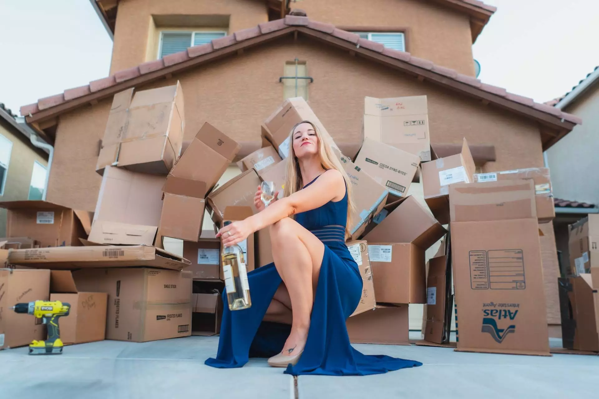 female homeowner with wine moving into a new home