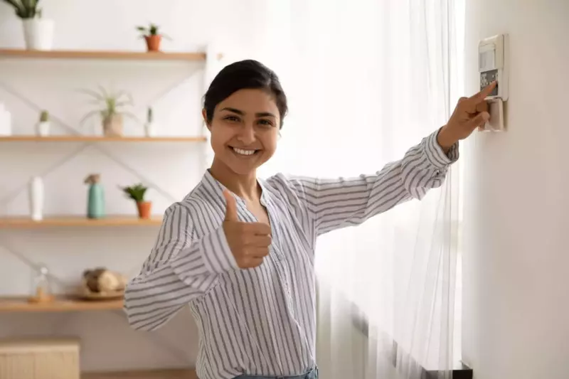 Woman checking thermostat