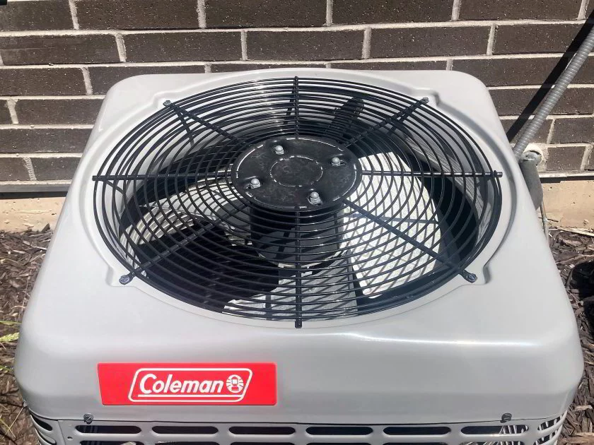 Outdoor AC condensing unit showing fan