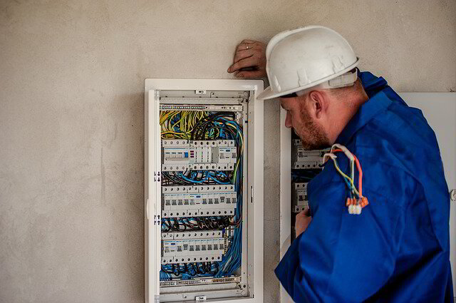 Electrician checking circuit panel