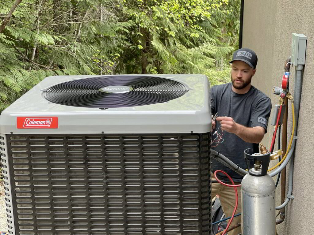 Phyxter Home Services HVAC Tech installing a Coleman Heat Pump