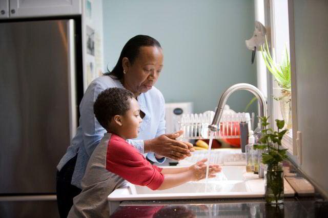 Mother and Son washing hands in a kitchen sink