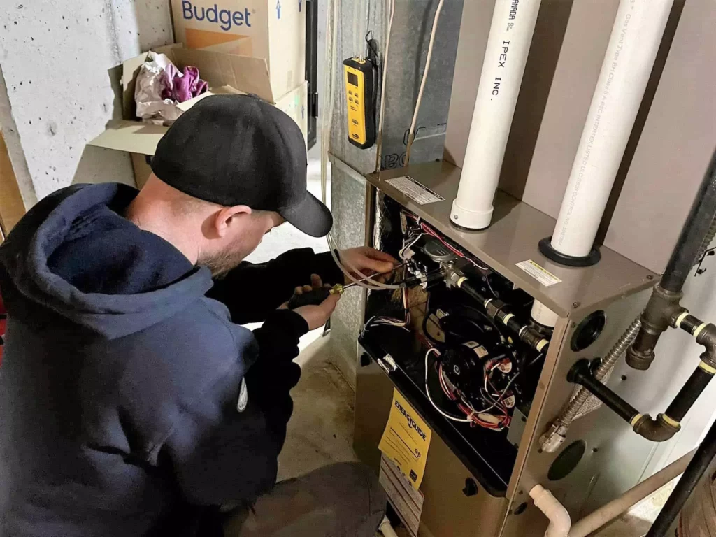 phyxter hvac tech repairing a furnace