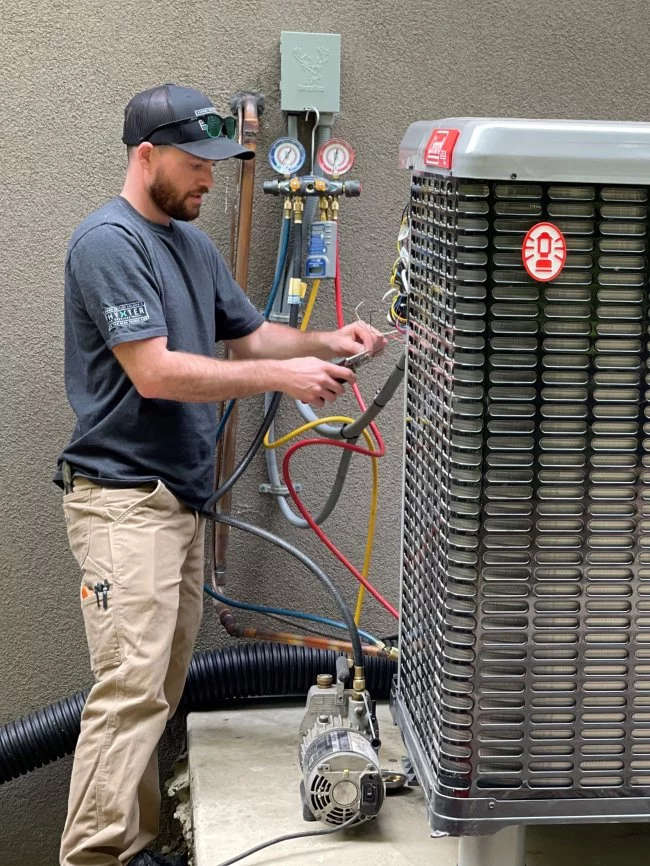Phyxter HVAC technician purging heat pump with nitrogen during installation