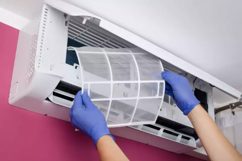 Woman installing a ductless mini split washable air filter