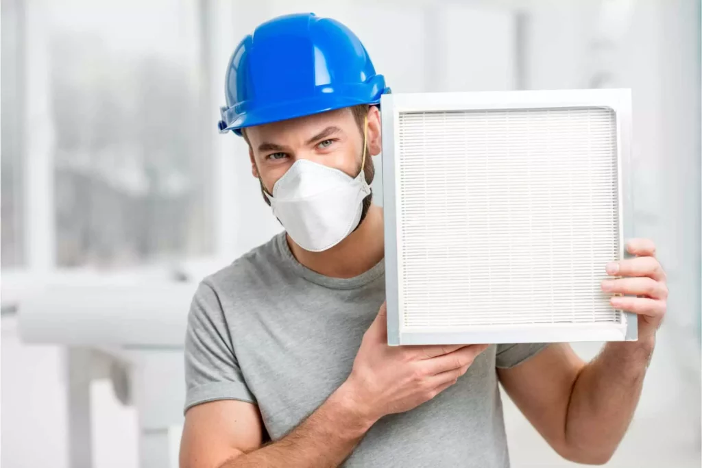 HVAC tech with a pleated air filter
