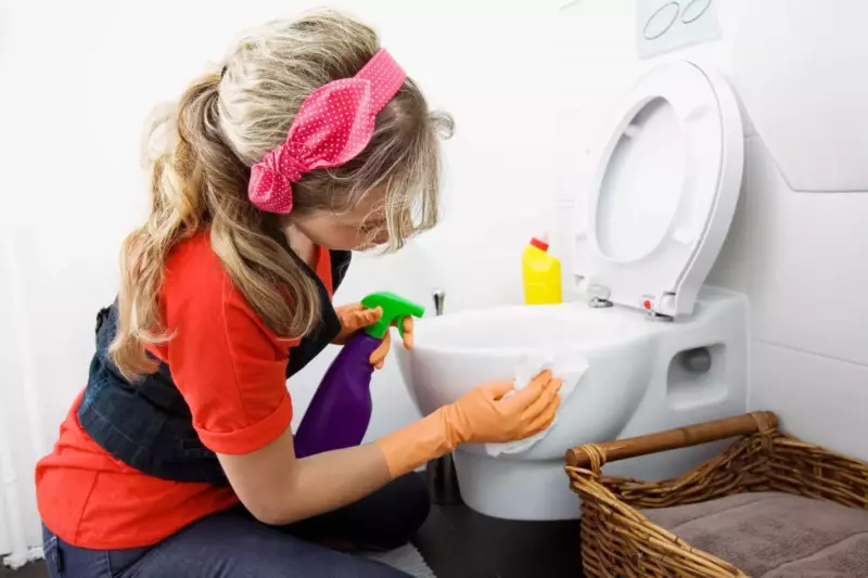 woman cleaning a toilet