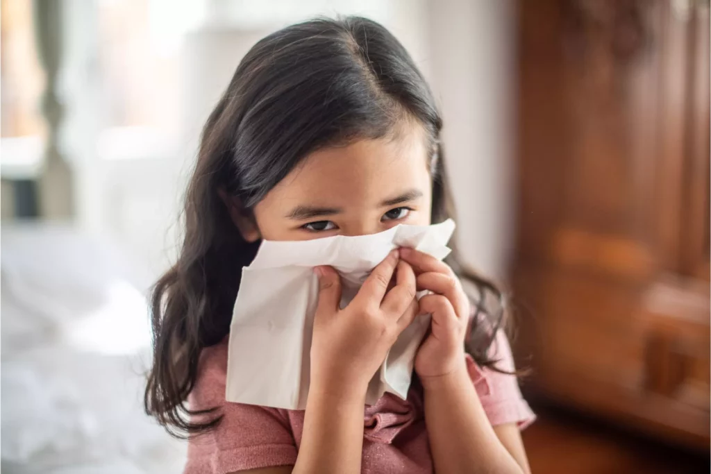 girl sneezing doe to poor indoor air quality