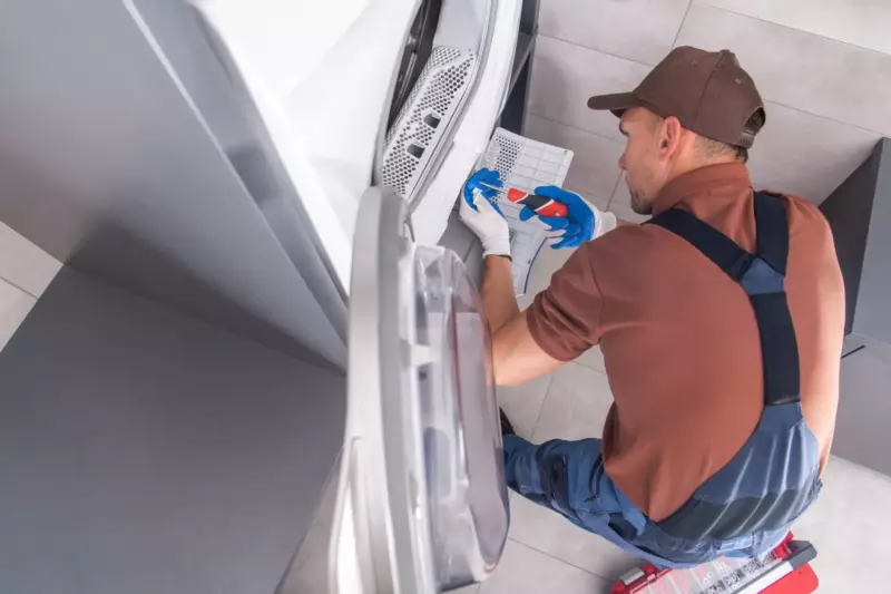 plumber repairing a washing machine