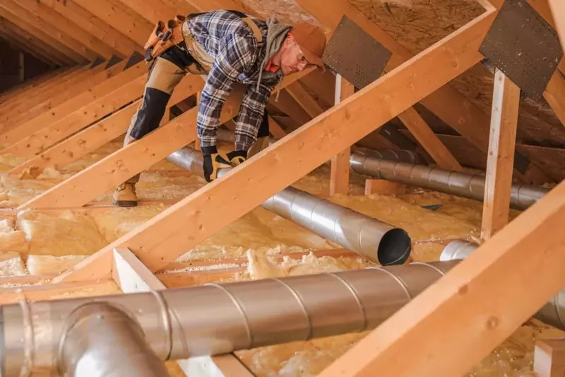 HVAC tech installing residential ductwork