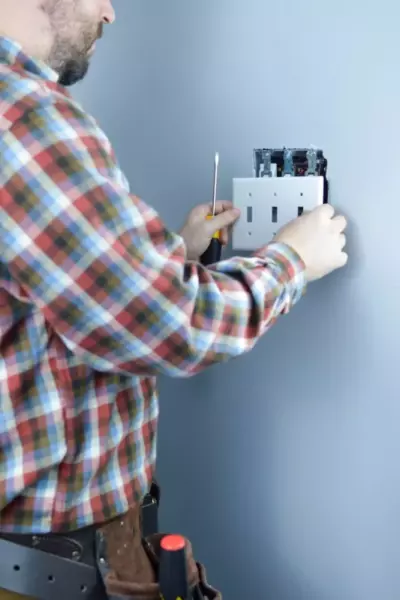 electrician replacing light switch