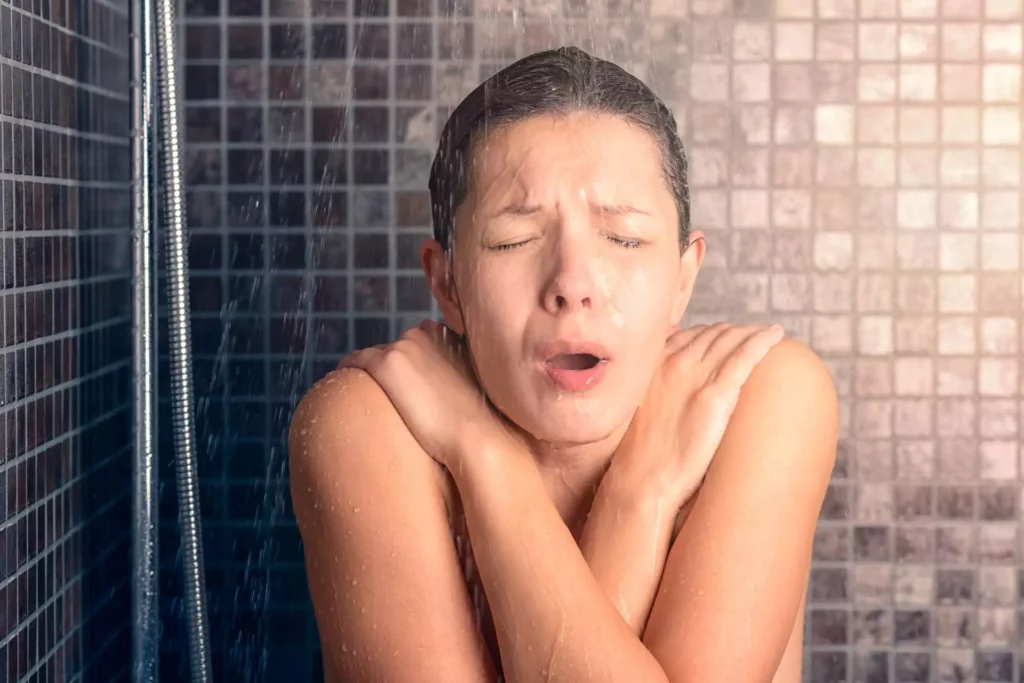 woman having a shower with low water pressure