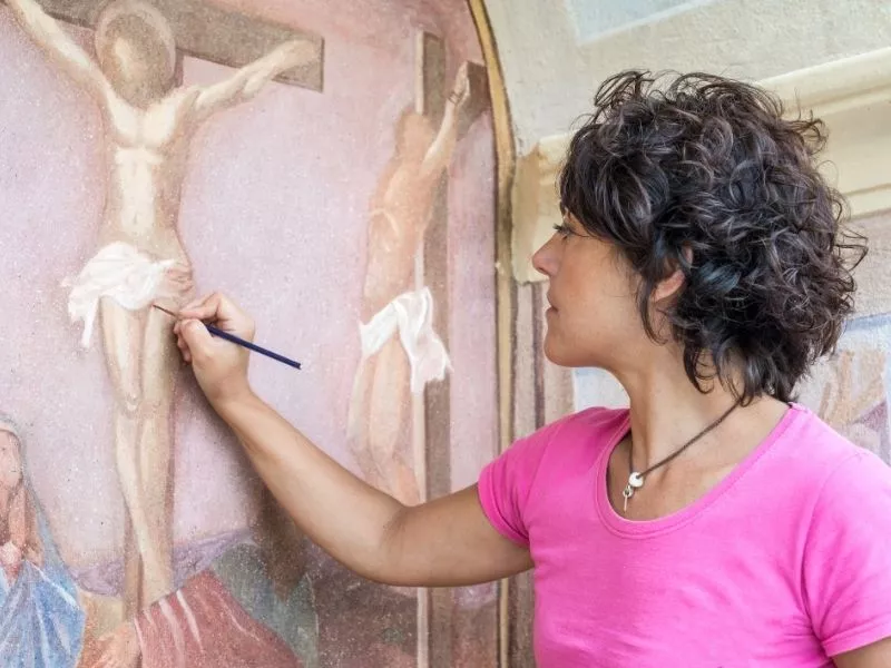 woman restoring artwork