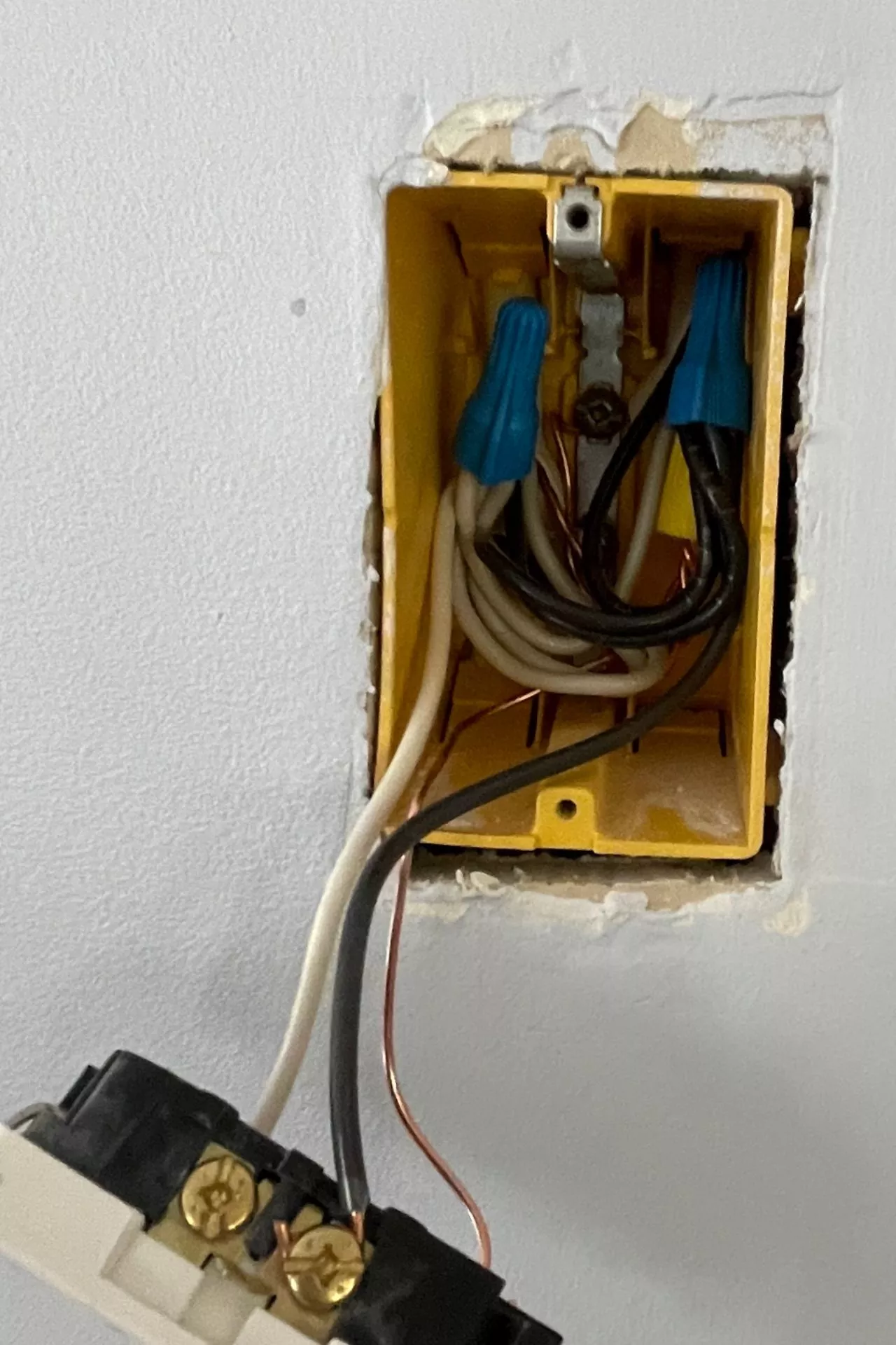 electrical outlet showing splices with the cover removed