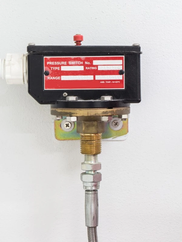 pressure switch mounted to a wall
