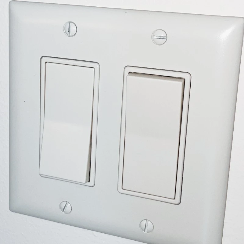 rocker style electrical switch mounted on wall