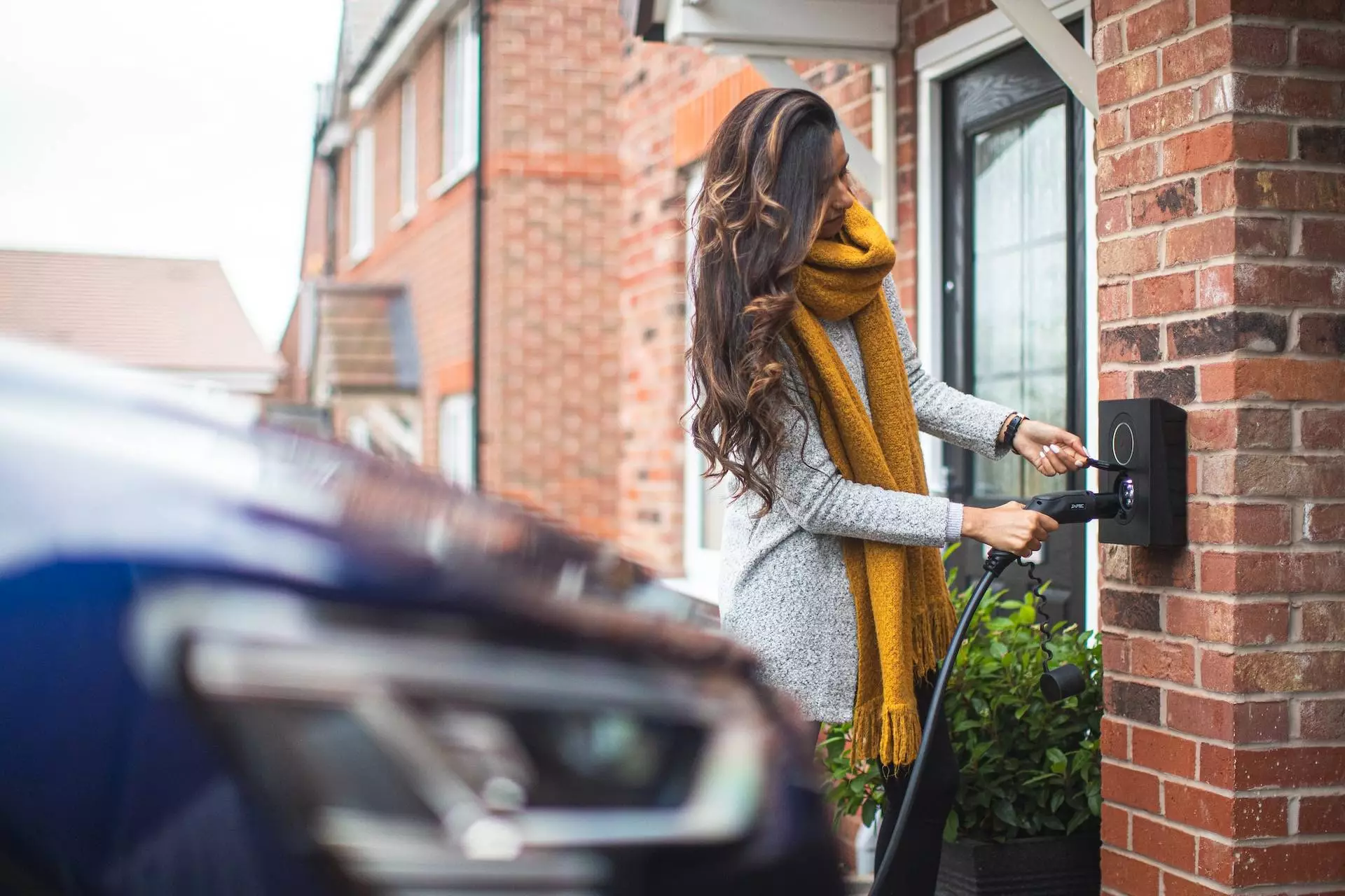 woman connecting a home EV charger